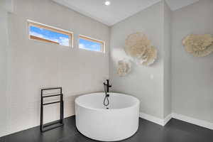 Bathroom with a bathing tub and tile patterned flooring