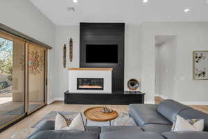 Living room featuring a fireplace and light wood-type flooring