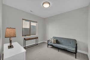 Sitting room featuring light colored carpet