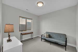 Sitting room with carpet floors and baseboards