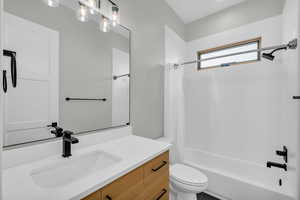 Full bathroom with vanity, toilet, and shower / bath combo