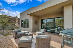 View of patio with outdoor lounge area and a grill