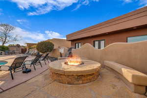 View of patio with a fire pit