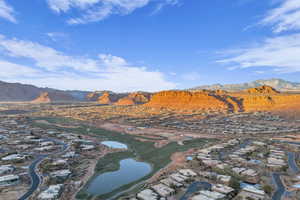 Aerial view of residential area with a water and mountain view and a local golf course
