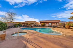 View of swimming pool featuring a patio area and a hot tub