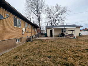 View of yard featuring central AC and a patio area