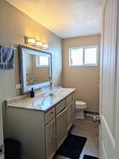 Full Bathroom with tile patterned flooring, vanity, a wealth of natural light, and toilet