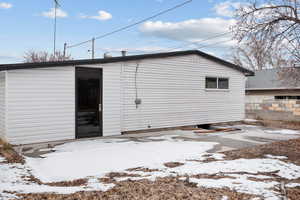 View of snow covered rear of property