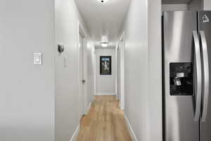 Hall featuring light hardwood / wood-style flooring