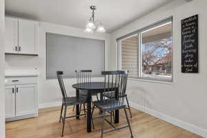 Dining space featuring an inviting chandelier and light hardwood / wood-style flooring