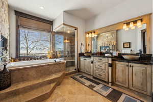 Bathroom featuring vanity and shower with separate bathtub