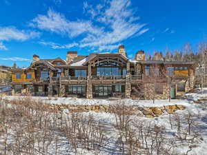 View of snow covered back of property