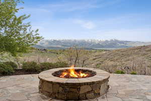 View of patio featuring an outdoor fire pit and a mountain view