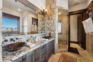 Bathroom featuring vanity, a mountain view, and walk in shower