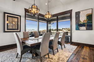 Dining space featuring an inviting chandelier and dark hardwood / wood-style flooring