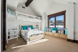 Bedroom with high vaulted ceiling, carpet flooring, and beam ceiling