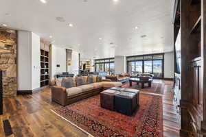 Living room with dark hardwood / wood-style floors and a fireplace