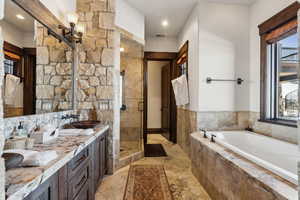 Bathroom with shower with separate bathtub and vanity