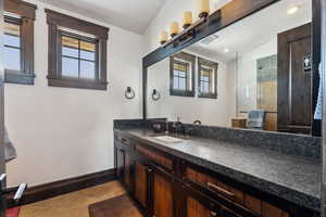 Bathroom with vanity, a wealth of natural light, tile patterned floors, and a shower with shower door