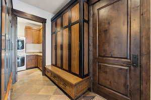 Mudroom with stacked washer and clothes dryer