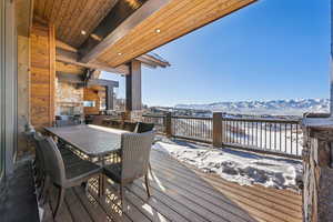 Snow covered deck with a mountain view