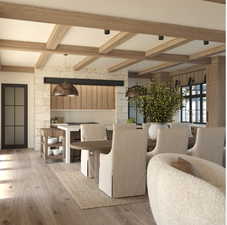 Dining room with beamed ceiling, coffered ceiling, and light hardwood / wood-style floors