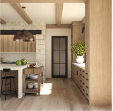 Interior space with beam ceiling and light hardwood / wood-style floors