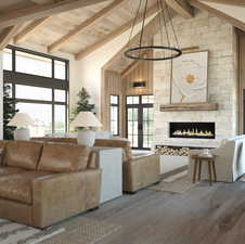 Living room featuring a wealth of natural light, high vaulted ceiling, hardwood / wood-style floors, and beam ceiling