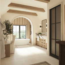 Primary Bathroom with vanity, a bath, and lofted ceiling with beams