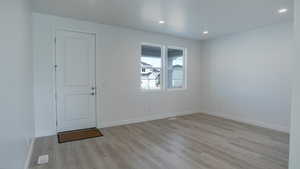 Interior space with light wood-type flooring, baseboards, and recessed lighting