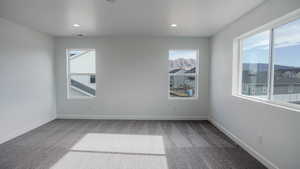 Unfurnished room featuring carpet, baseboards, and recessed lighting