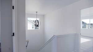 Interior space featuring baseboards, carpet floors, and a notable chandelier