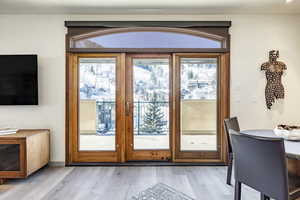 Doorway to outside with light hardwood / wood-style floors