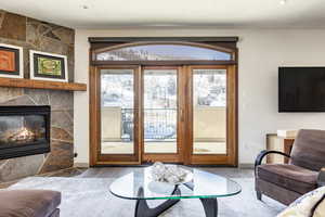 Living room with hardwood / wood-style flooring and a fireplace