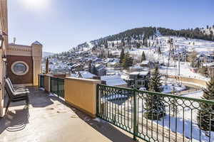 View of snow covered back of property