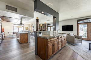 Kitchen featuring sink, a center island, hardwood / wood-style floors, and a textured ceiling