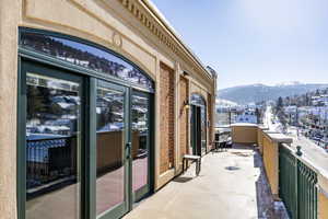 Snow covered back of property featuring a mountain view