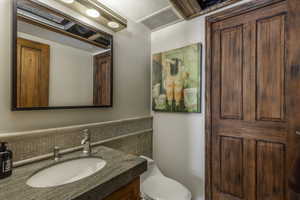 Bathroom featuring vanity and toilet