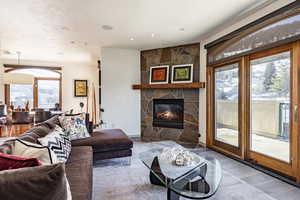 Living room with a fireplace and wood-type flooring