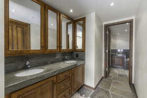 Bathroom with tasteful backsplash and vanity