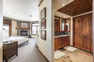 Bathroom with vanity, backsplash, and a premium fireplace