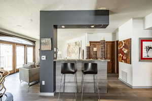 Bar featuring hardwood / wood-style floors