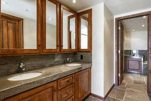 Bathroom with vanity and backsplash