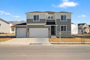 View of front of house with a garage and a mountain view