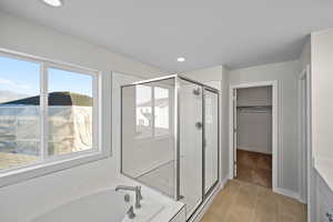 Bathroom with shower with separate bathtub, tile patterned floors, and vanity