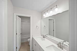 Bathroom with tile patterned flooring, vanity, and toilet