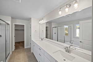 Bathroom with vanity, separate shower and tub, and tile patterned flooring