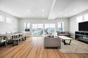 Living room with a textured ceiling and light hardwood / wood-style floors