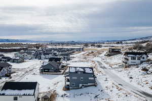 Snowy aerial view featuring a mountain view