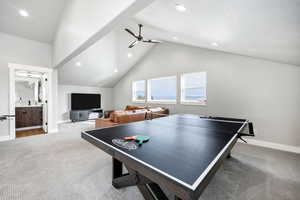 Game room featuring carpet, high vaulted ceiling, a textured ceiling, and ceiling fan